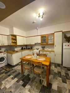 a kitchen with a wooden table and chairs at Maria,s house in Petra