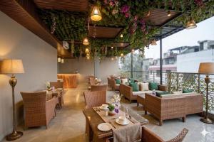 a restaurant with tables and chairs and flowers at The Shanti Plaza - Traveler's choice awarded 2025 - New Delhi Railway Station, Paharganj in New Delhi