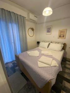 a bedroom with a bed with two towels on it at Maria,s house in Petra