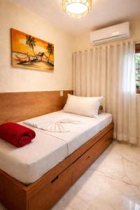 a bedroom with a large bed with at Residence Pé na Areia in Arraial d'Ajuda