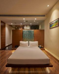 a bedroom with a large bed in a room at Hotel Studio Estique in Pune