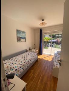 a bedroom with a bed and a sliding glass door at Villa Osher in Saint-Raphaël +19 photos