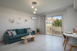 a living room with a green couch and a table at Kamara View Apt 2 in Agios Nikolaos +5 photos