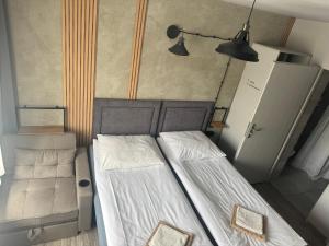 a small bedroom with two beds and a lamp at Guest Apartments Orłowo in Gdynia +102 photos
