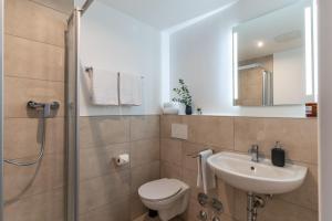 a bathroom with a toilet and a sink and a shower at Jotica Colonia in Cologne +54 photos