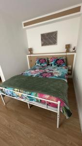 a bed in a room with a bed frame at Chambres mimi deni in Hésingue