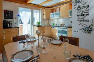 a kitchen with a table with wine glasses on it at Penthouse Jasmin in Laces