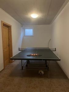 a ping pong table in the middle of a room at Apartmán pri Dierach in Terchová