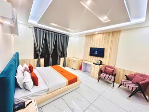 a hotel room with a bed and a tv at The Pranav Retreat A Premium Property in Nainital