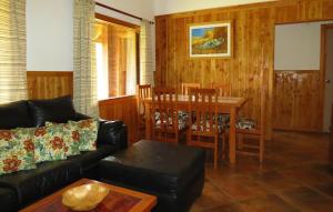 a living room with a couch and a table and chairs at Cabañas Alto Caburgua in Caburgua