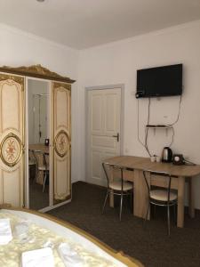 a room with a table and a mirror and a bed at Міні Готель Особняк in Lviv