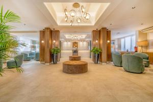 a lobby with a waiting room with chairs and a table at Morlans Garden in Paguera +41 photos