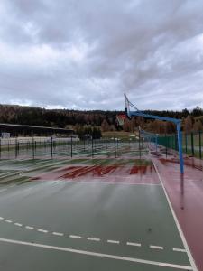 an empty basketball court with a basketball hoop at Marla 52 in Le Dévoluy