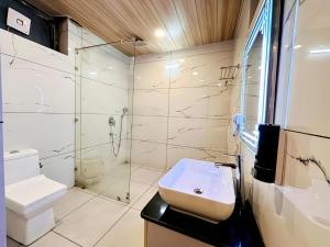 a bathroom with a toilet and a sink and a shower at The Pranav Retreat A Premium Property in Nainital +63 photos