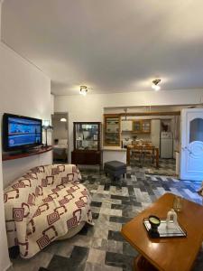 a living room with a bed and a table and a tv at Maria,s house in Petra