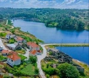 an aerial view of a house next to a lake at Casa D'os Eiras in Aguiar da Beira