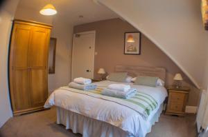 a bedroom with a bed with towels on it at The Chateau by MPH Holidays in Great Yarmouth
