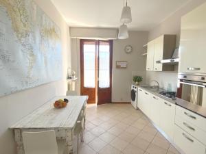 a kitchen with a table and a map on the wall at Casa Carmen Vicchio, natura vicino a stazione e Mugello Circuit in Vicchio
