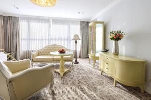 a living room with a couch and a table at Bristol Central Park Hotel in Chişinău