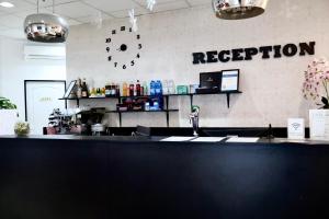 a counter in a restaurant with a clock on the wall at Triple M Hotel in Budapest