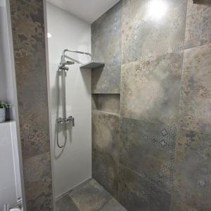 a bathroom with a shower with a glass door at Apartments Emilija in Brela +37 photos