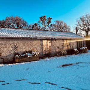a building with snow on the ground in front of it at Gite du Bois Passé in Bourgneuf-en-Retz