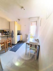 a kitchen with a table and chairs in a room at Luino Flowers Home in Luino