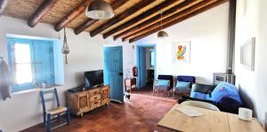 a living room with a couch and a table at Monte Costa Raiz in Mértola