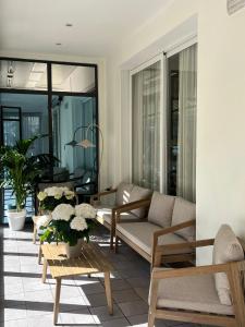 a living room with a couch and chairs and tables at Hotel Ferrara in Cattolica