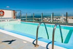 a swimming pool with a view of the ocean at Casa Vista Mar Oliastur El Cotillo in El Cotillo