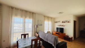 a living room with a couch and a television at Casa Vista Mar Oliastur El Cotillo in El Cotillo