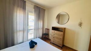 a bedroom with a bed and a mirror and a dresser at Casa Vista Mar Oliastur El Cotillo in El Cotillo +27 photos