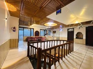 a lobby with a staircase and a living room at The Pranav Retreat A Premium Property in Nainital