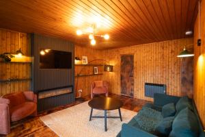 a living room with a couch and a table at Kingswood Pods and Lodges in Fort William