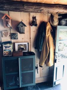 a room with a wooden wall with a cabinet and pictures at VeNeZ DoRmiR dans notre Bergerie au Cœur des Pyrénées Hebergement atypique in Bordères-Louron