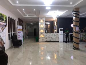 a lobby with a person standing in a room at Pearl Paradise Resort by 4E in Finima