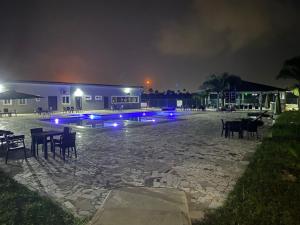 a building with tables and chairs at night at Pearl Paradise Resort by 4E in Finima