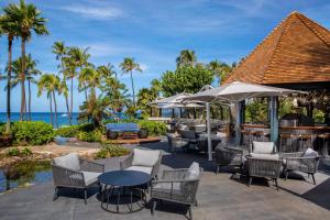 a patio with tables and chairs and the ocean at The Westin Maui Resort & Spa, Ka'anapali in Lahaina