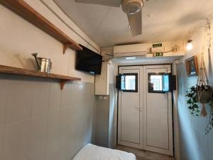 a small room with a door and a bed in it at Estúdio Madragoa in Lisbon