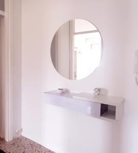 a bathroom with a mirror and a sink at Luino Flowers Home in Luino