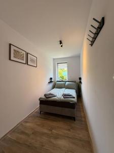 a bedroom with a bed and a window at Hostel Róża in Żywiec