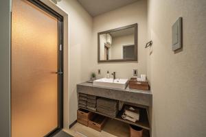 a bathroom with a sink and a mirror at 在-Zai- in Beppu +24 photos