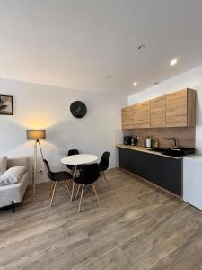 a kitchen and a living room with a table and chairs at Hostel Róża in Żywiec