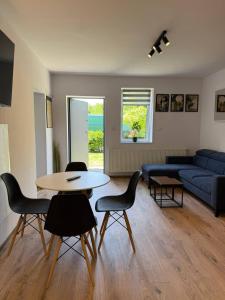 a living room with a table and chairs and a couch at Hostel Róża in Żywiec +19 photos