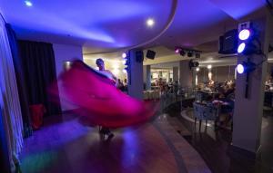 a person in a dress dancing on a dance floor at Hotel Lanzarote Village in Puerto del Carmen +74 photos
