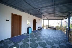 a room with a balcony with a door and a floor at sinhgad hills in Kharakvasla