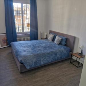 a bedroom with a large bed with a blue blanket at veeweyde in Brussels