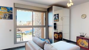 a living room with a couch and a large window at Beach Apartment Marfolin 06 El Cotillo in El Cotillo +20 photos