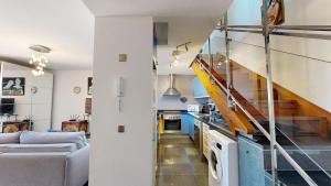 a kitchen and a living room with a staircase at Beach Apartment Marfolin 06 El Cotillo in El Cotillo