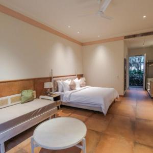 a bedroom with two beds and a table and a table at The Forresta Checks-In, Jaipur in Jaipur